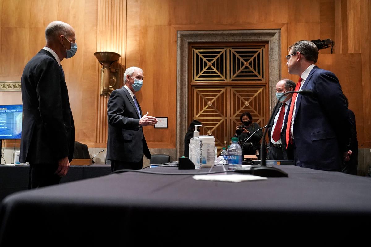 Sen. Rick Scott (R-Fla.) (2nd-L) and Senate Homeland Security and Governmental Affairs Committee Chairman Ron Johnson (R-Wis.) (L) speak to Trump campaign attorneys James Troupis and Jesse Binnall before a Senate Homeland Security and Governmental Affairs Committee hearing to discuss election security and the 2020 election process in Washington on Dec. 16, 2020. (Greg Nash-Pool/Getty Images)
