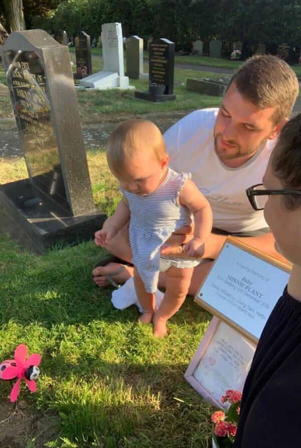 Sam and Florence with baby Hettie at Minnie's grave. (Caters News)