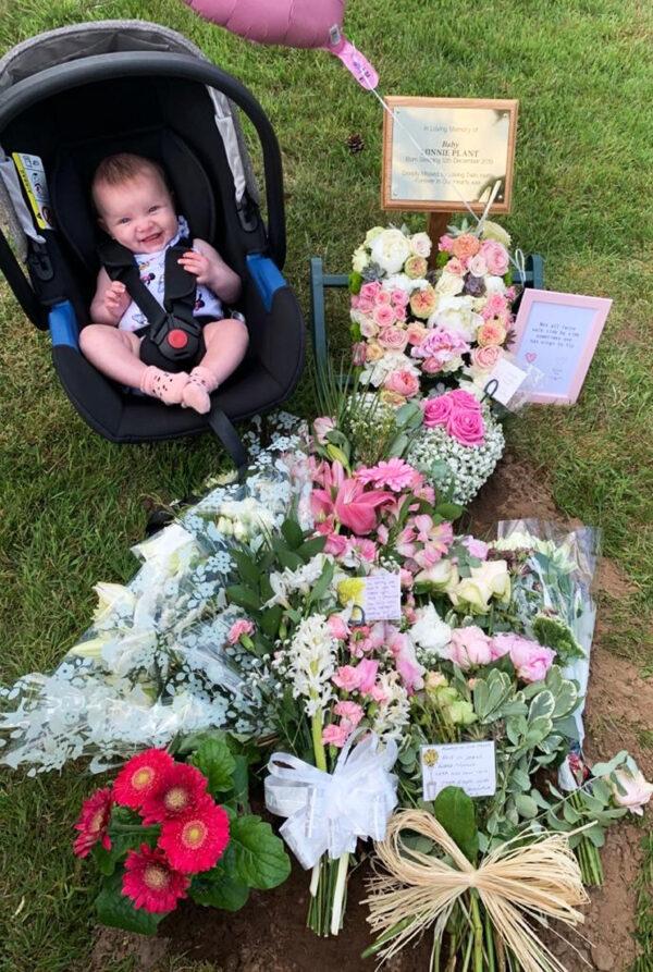 Baby Hettie at the grave of her twin sister, Minnie. (Caters News)