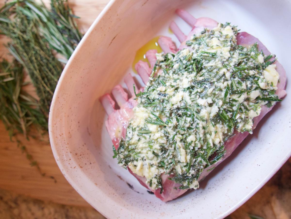 A coat of herb butter keeps makes the lamb flavorful and juicy as it roasts. (Victoria de la Maza)