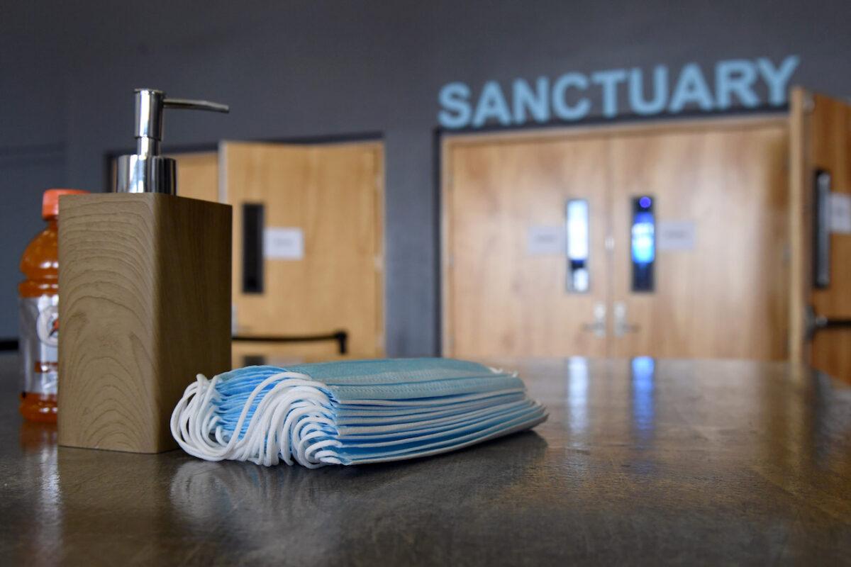 Hand sanitizer and surgical masks are placed on tables for those that want to use them at the sanctuary entrance of the International Church of Las Vegas in Las Vegas, Nev., on May 31, 2020. (Ethan Miller/Getty Images)