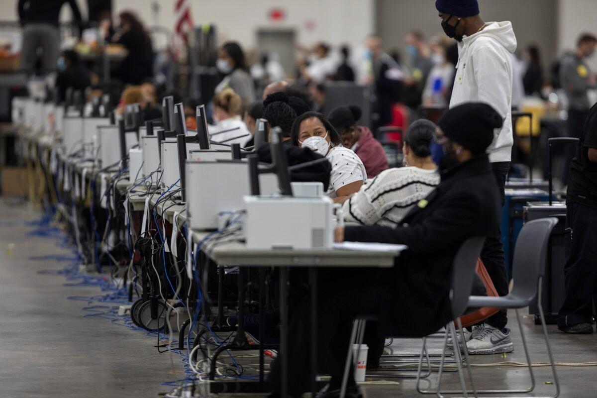 Workers with the Detroit Department of Elections wait to process absentee ballots at the Central Counting Board in the TCF Center in Detroit, on Nov. 4, 2020. (Elaine Cromie/Getty Images)
