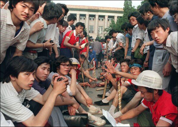 Students armed with wooden sticks gather outside the Great Hall of the People on Tiananmen Square in Beijing during pro-democracy protests on June 3, 1989. That night and the following day, People’s Liberation Army troops used lethal force to end the weeks-long protests by students, killing <span class="ILfuVd NA6bn c3biWd"><span class="hgKElc">several thousand, with thousands more wounded.</span></span> (Catherine Henriette/AFP via Getty Images)