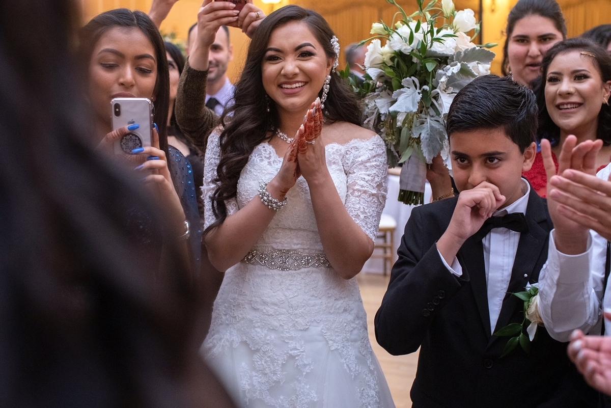 Anum Mossa enjoying her sister's reaction to her now-brother-in-law's proposal on her wedding day. (Courtesy of <a href="https://www.instagram.com/hellaanum/">Anum Mossa</a>)