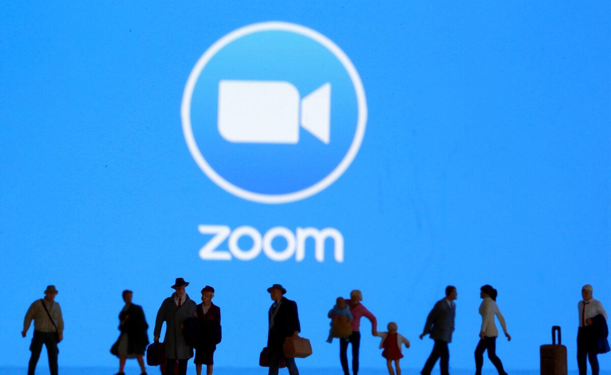 Small toy figures are displayed in front of a Zoom logo in this illustration taken on March 19, 2020. (Reuters/Dado Ruvic/Illustration)