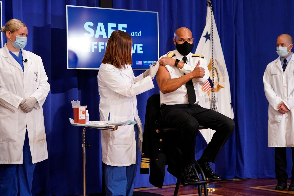 Surgeon General Jerome Adams receives a Pfizer-BioNTech COVID-19 vaccine shot at the Eisenhower Executive Office Building on the White House complex in Washington on Dec. 18, 2020. (Andrew Harnik/AP Photo)