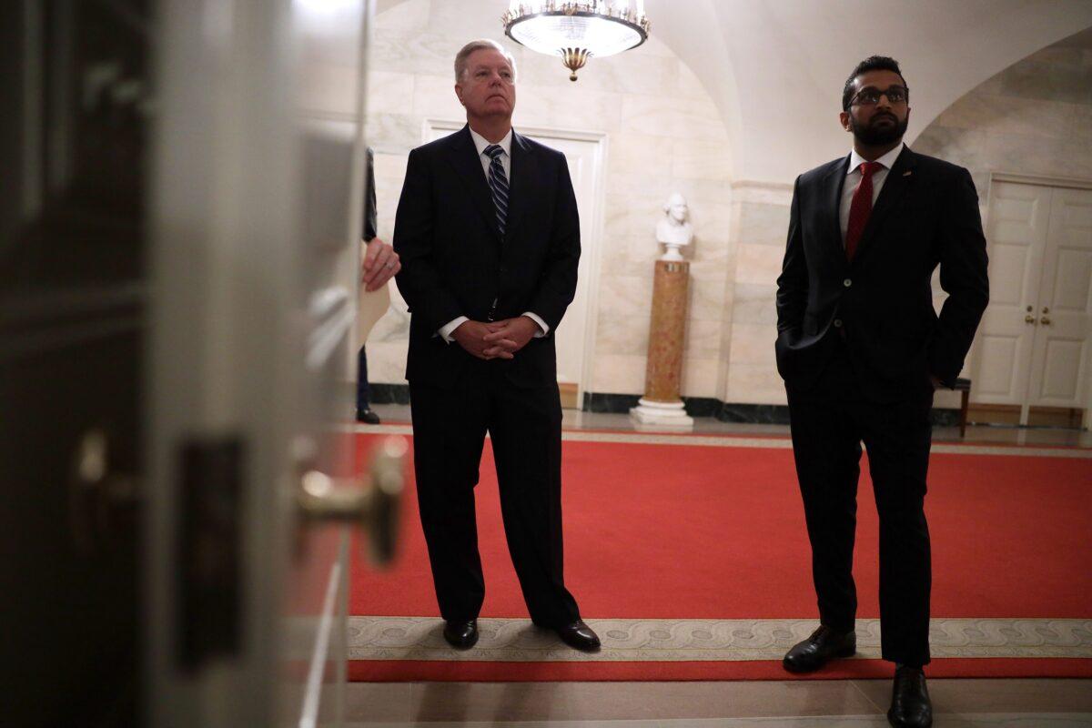 (R) Kash Patel, then-National Security Council director of counterterrorism, stands with Sen. Lindsey Graham (R-S.C.) in the White House in Washington on Oct. 29, 2019. (Alex Wong/Getty Images)