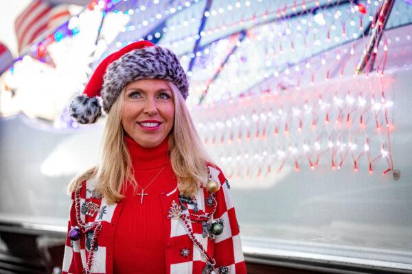 Caroline Wetherington, co-organizer of the unofficial Newport Harbor Christmas Boat Parade, stands in front of her boat in Newport Beach, Calif., on Dec. 17, 2020. (John Fredricks/The Epoch Times)