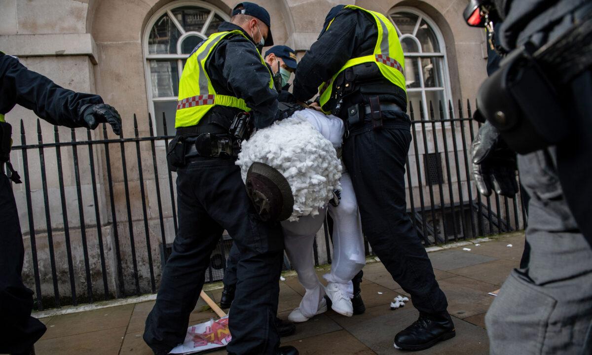 A man dressed as a snowman is arrested during an anti lockdown protest in London on Dec. 19, 2020. (Chris J Ratcliffe/Getty Images)