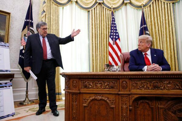 Attorney General William Barr (L) speaks with President Donald Trump during briefing in the Oval Office of the White House in Washington in a file photo. (Patrick Semansky/AP Photo)
