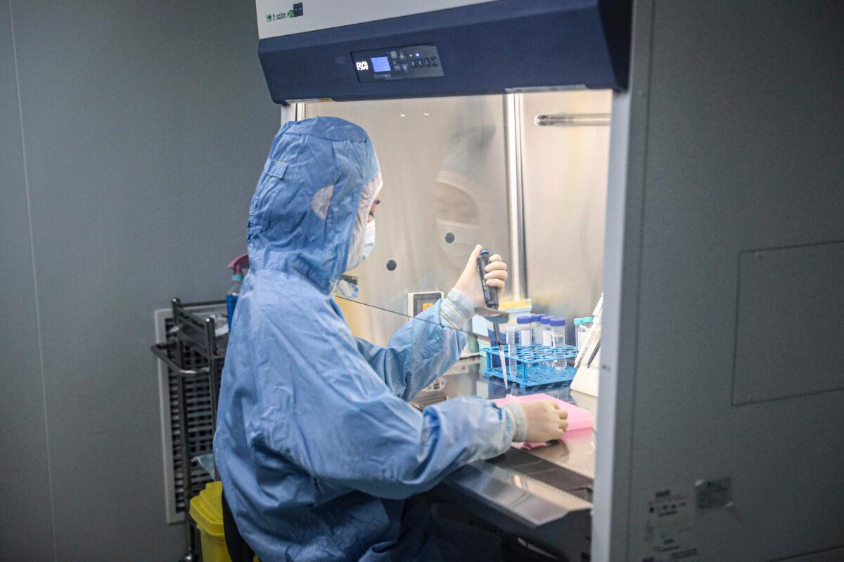 An employee works on COVID-19 detection kits in a laboratory of the Chinese company Biotech & Biomedicine Group in Shenyang, China, on Dec. 14, 2020. (STR/AFP via Getty Images)
