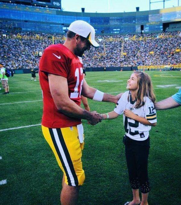 Moscato, 11, with football player Aaron Rodgers, after singing the national anthem on Family Night at Lambeau Field in Green Bay, Wis., in 2013. (Kathy Sakschek)