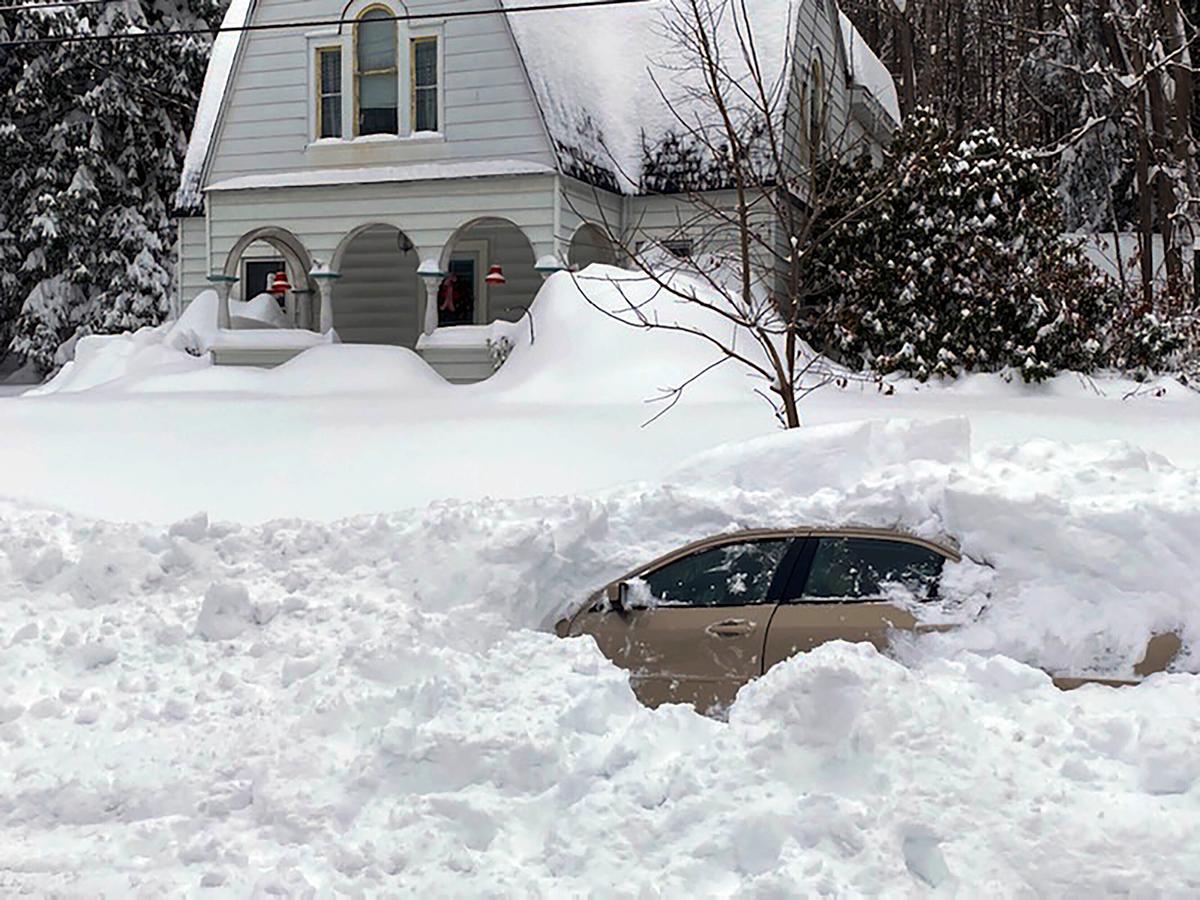 This photo, provided by the New York State Police, shows a car, in Owego, N.Y., from which a New York State Police sergeant rescued the 58-year-old Candor man stranded for 10 hours, covered by nearly 4 feet of snow. (New York State Police via AP)