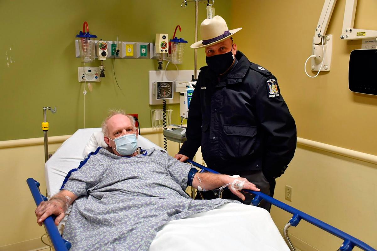 Kevin Kresen, 58, and New York State Police Sgt. Jason Cawley at Lourdes Hospital, in Binghamton, N.Y. Cawley rescued Kresen from his car, in Owego, N.Y., where he was stranded for 10 hours, covered by nearly 4 feet of snow. (New York State Police via AP)