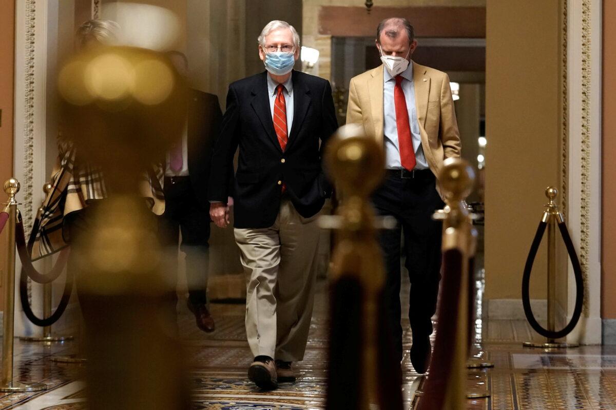 Senate Majority Leader Mitch McConnell (R-Ky.) (L) walks from his office to the Senate floor on Capitol Hill in Washington on Dec. 20, 2020. (Ken Cedeno/Reuters)