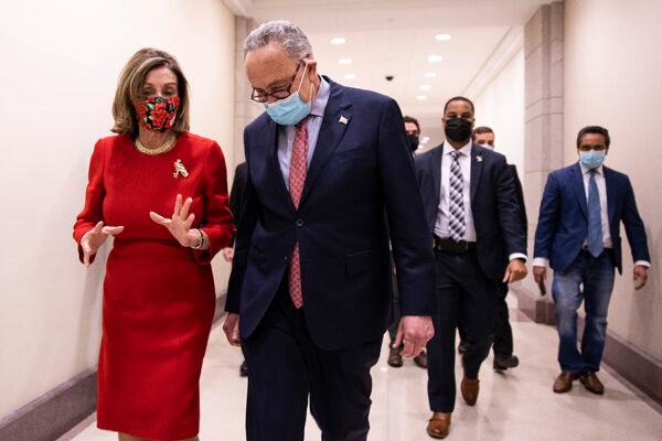 House Speaker Nancy Pelosi (D-Calif.), left, and Senate Minority Leader Chuck Schumer (D-N.Y.) walk on Capitol Hill on Dec. 20, 2020. (Tasos Katopodis/Getty Images)