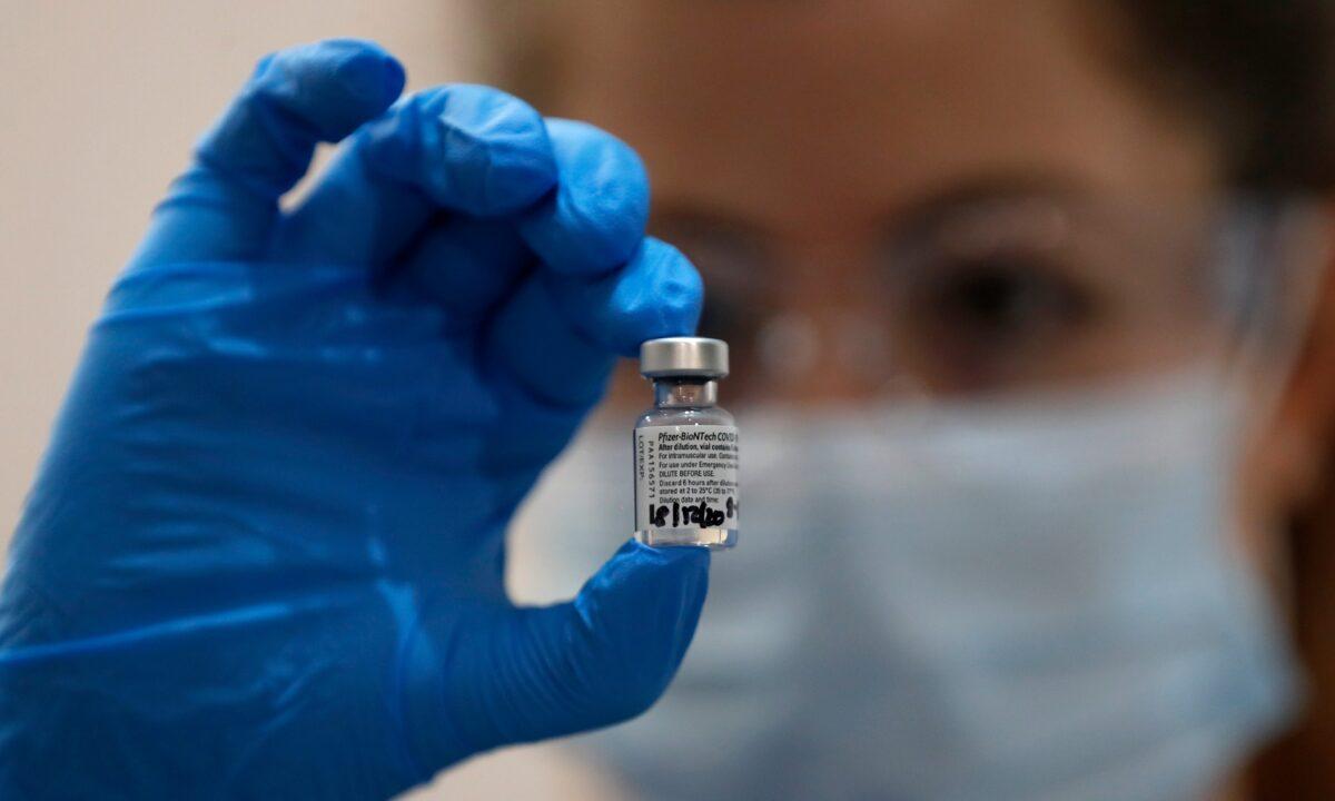 A nurse holds a vial of the Pfizer-BioNTech COVID-19 vaccine at Guy's Hospital in London, on Dec. 8, 2020. (Frank Augstein/AP Photo)