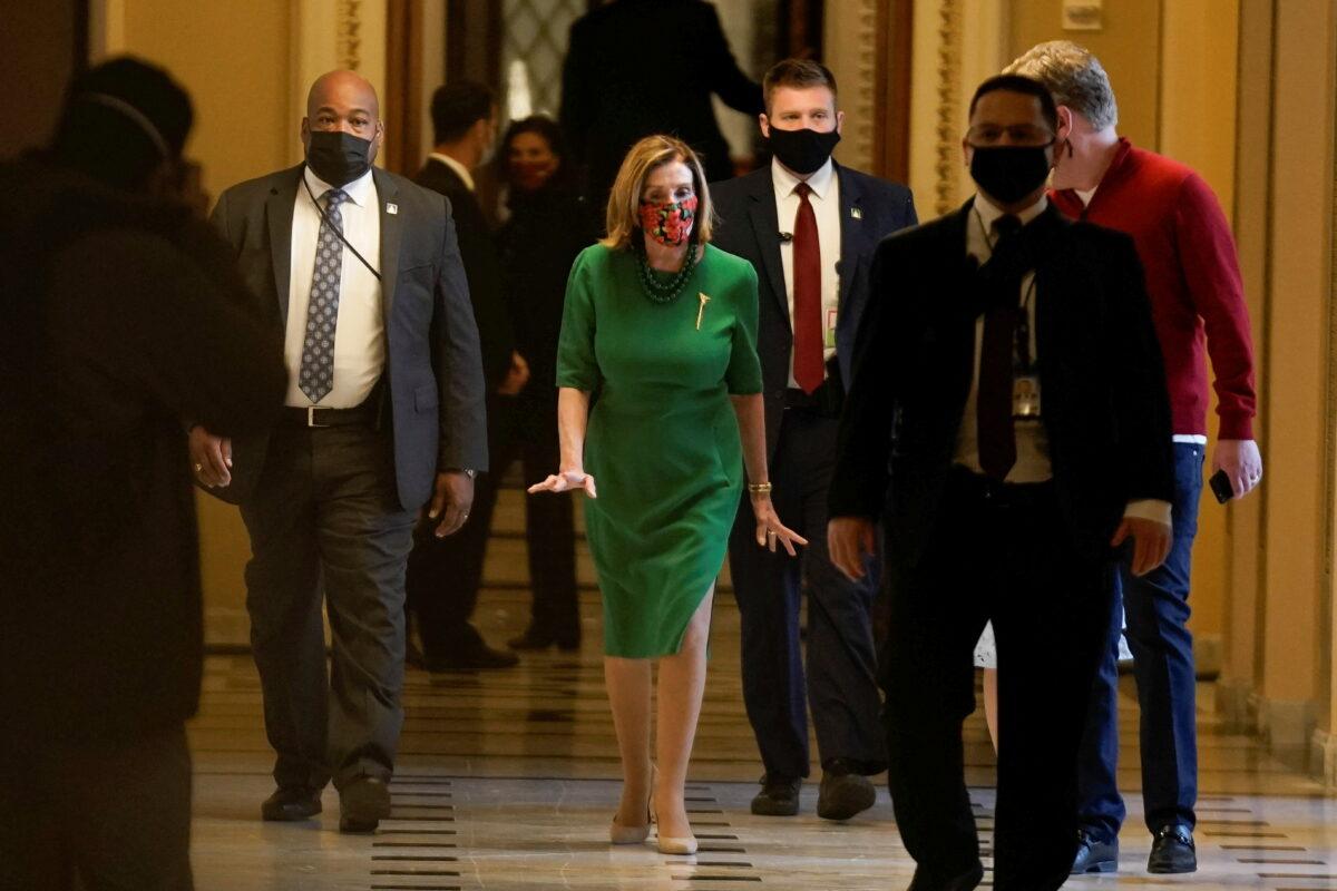 House Speaker Nancy Pelosi (D-Calif.) walks back to her office on Capitol Hill in Washington on Dec. 21, 2020. (Ken Cedeno/Reuters)