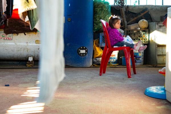 A child sits in Casas De Dios foster home in Tijuana, Mexico, on Dec. 19, 2020. (John Fredricks/The Epoch Times)