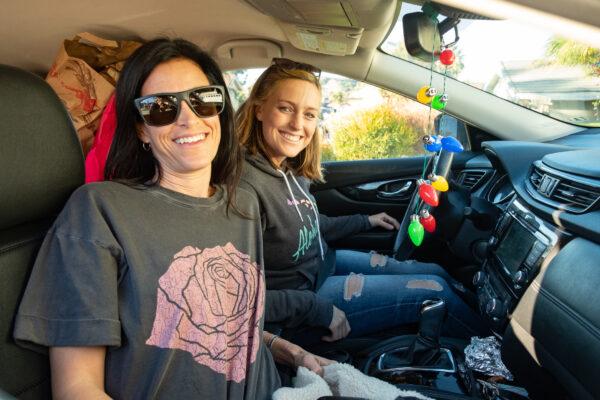 Volunteers Keli Kabtibian (L) and Ashley Austin (R) prepare for the drive to Casas De Dios foster home from Mission Viejo, Calif., on Dec. 19, 2020. (John Fredricks/The Epoch Times)