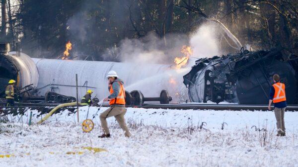 A firefighter sprays foam on burning, derailed train cars in Custer, Wash., on Dec. 22, 2020. (Elaine Thompson/AP Photo)