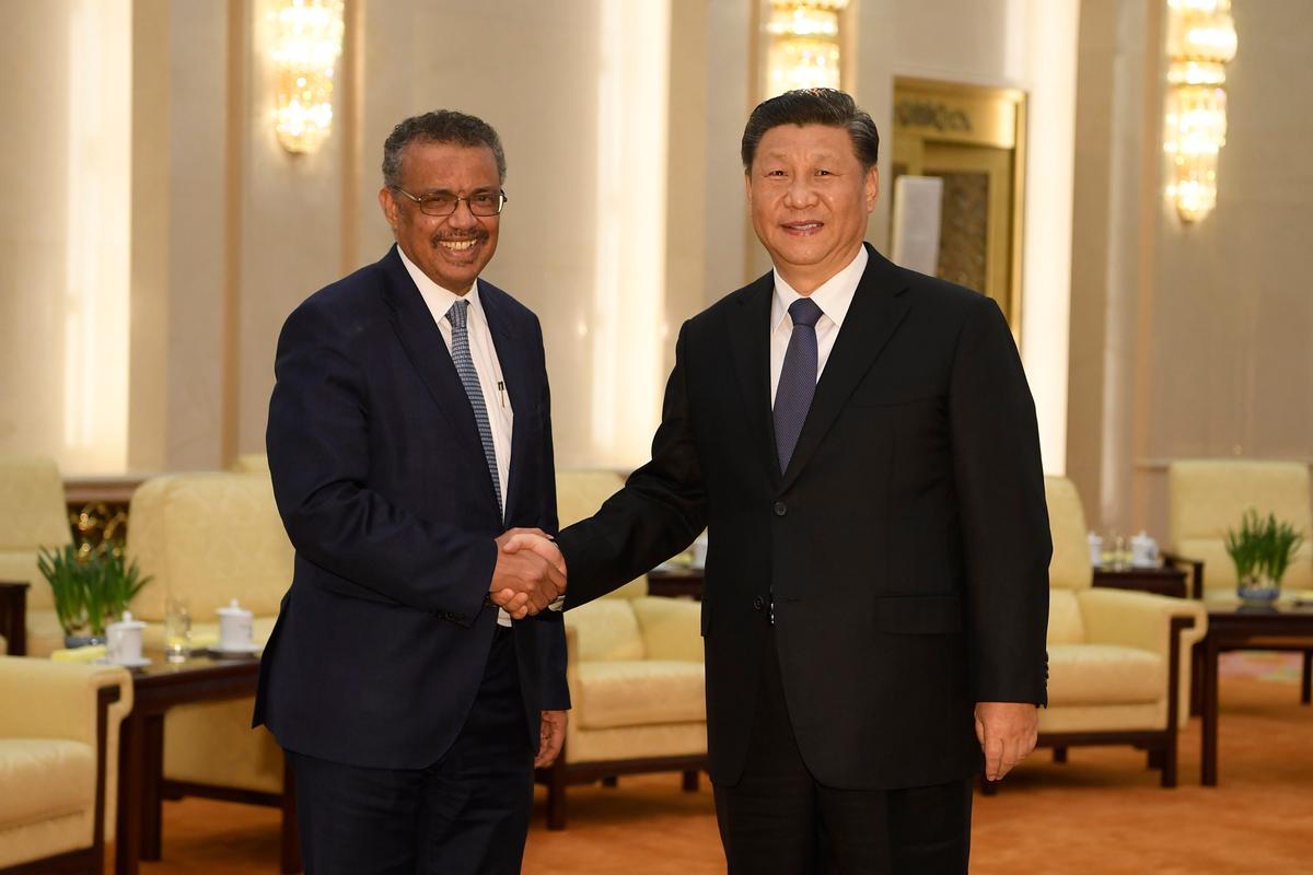 Tedros Adhanom, director-general of the World Health Organization, left, shakes hands with Chinese President Xi Jinping before a meeting at the Great Hall of the People in Beijing on Jan. 28, 2020. (Naohiko Hatta/AP)