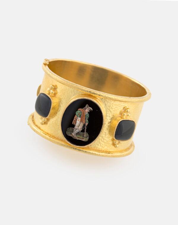 "Peasant Man With Walking Stick, Rome," 19th century, after etchings by Bartolomeo Pinelli. Micromosaic reset in wide, hammered gold bangle with rolled edges and side black jade cushions with gold triads; 1 3/8 inches by 2 1/2 inches by 2 3/8 inches. Collection of Elizabeth Locke. (Travis Fullerton/Virginia Museum of Fine Arts)
