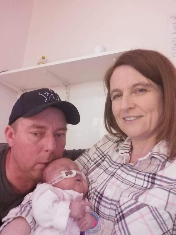 Scott Woodland and Emma Griffin with their baby daughter Iris. (Caters News)