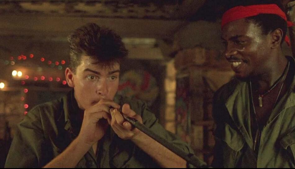 Chris Taylor (Charlie Sheen) having a “smoke” and King (Keith David) enjoying the "new meat"-awkwardness, in “Platoon." (Orion Pictures)