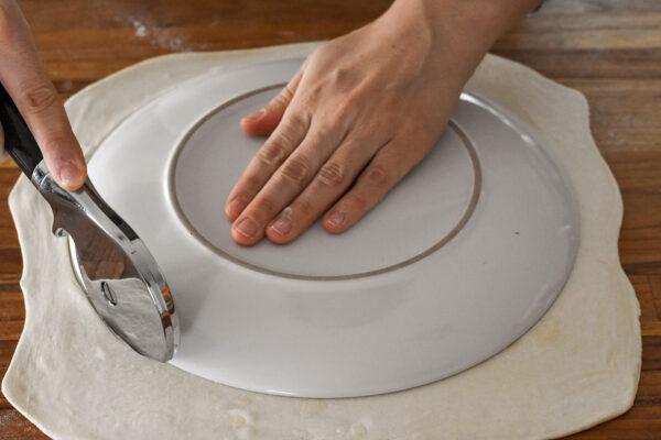 Use a plate or cake pan to cut out circles of puff pastry. (Audrey Le Goff)