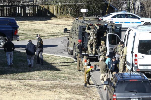 Law enforcement officers investigate the house previously belonging to Anthony Quinn Warner, a 63-year-old man who has been reported to be of interest in the Nashville RV bombing, in Nashville, Tenn., on Dec. 26, 2020. (Terry Wyatt/Getty Images)