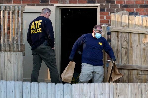 FBI and ATF agents investigate a home connected to the Christmas Day bombing, in Nashville, Tenn., on Dec. 26, 2020. (Mark Humphrey/AP Photo)