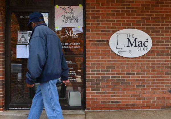 A man walks past "The Mac Shop" in Wilmington, Delaware on Ocrt 21, 2020. (Angela Weiss/AFP via Getty Images)