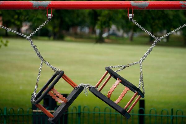 Children's play swings remained locked and chained, due to the CCP virus pandemic, in Leicester, England, before non-essential shops closed for the localised lockdown on June 30, 2020. (Christopher Furlong/Getty Images)