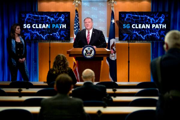 Screens that read 5G Clean Path with a map of the United States are visible behind Secretary of State Mike Pompeo, accompanied by State Department spokeswoman Morgan Ortagus (L), as he speaks at a news conference at the State Department in Washington, on April 29, 2020. (Andrew Harnik/AFP via Getty Images)