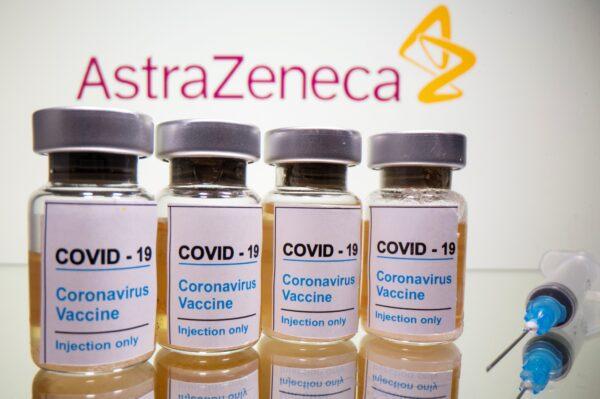 Vials with a sticker reading "COVID-19 / Coronavirus vaccine / Injection only" and a medical syringe are seen in front of a displayed AstraZeneca logo in this illustration taken on Oct. 31, 2020. (Dado Ruvic/Illustration/File Photo/Reuters)