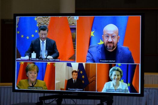 European Commission President Ursula von der Leyen, European Council President Charles Michel, German Chancellor Angela Merkel, French President Emmanuel Macron, and Chinese President Xi Jinping are seen on a screen during a video conference, in Brussels, on Dec. 30, 2020. (Johanna Geron/Pool/Reuters)