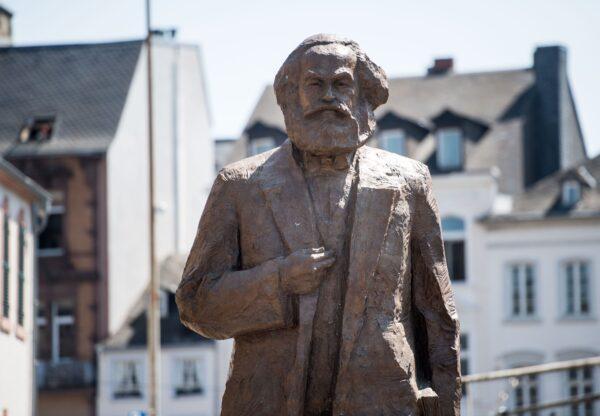 The sculpture of German philosopher and revolutionary Karl Marx is uncovered during its inauguration at the 200th anniversary of the birth of Karl Marx in Trier, Germany, on May 5, 2018. (Thomas Lohnes/Getty Images)