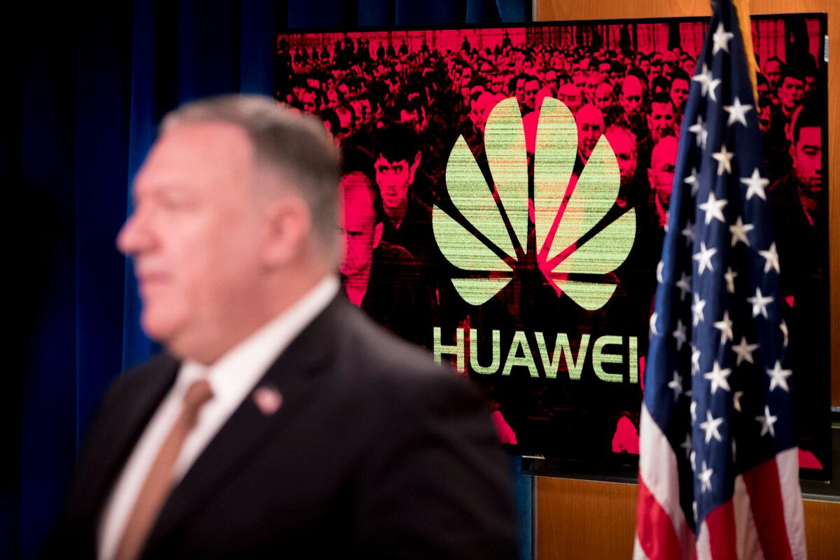 A monitor displays the Huawei logo behind then Secretary of State Mike Pompeo during a news conference at the State Department in Washington on July 15, 2020. (Andrew Harnik/POOL/AFP via Getty Images)