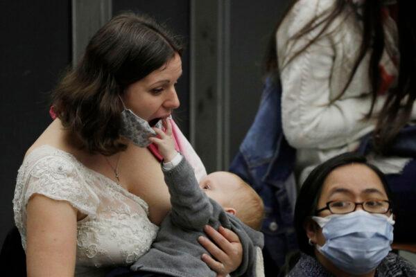 A mother breasts feed her daughter in the Paul VI hall at the Vatican, Italy, on Oct. 21, 2020. (Gregorio Borgia/AP Photo)