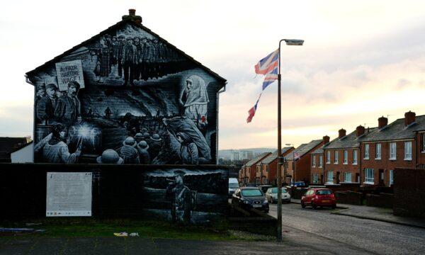 A tattered Union Jack flag hangs from a lamppost on a terraced street in Belfast, Northern Ireland, on Dec. 30, 2020. (Phil Noble/Reuters)