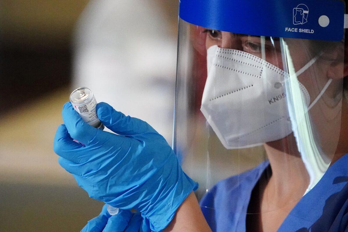 A nurse prepares a syringe with the COVID-19 Moderna vaccine for a worker of the New York City Fire Department Bureau of Emergency Medical Services, amid the COVID-19 pandemic in Manhattan on Dec. 23, 2020. (Carlo Allegri/Reuters)