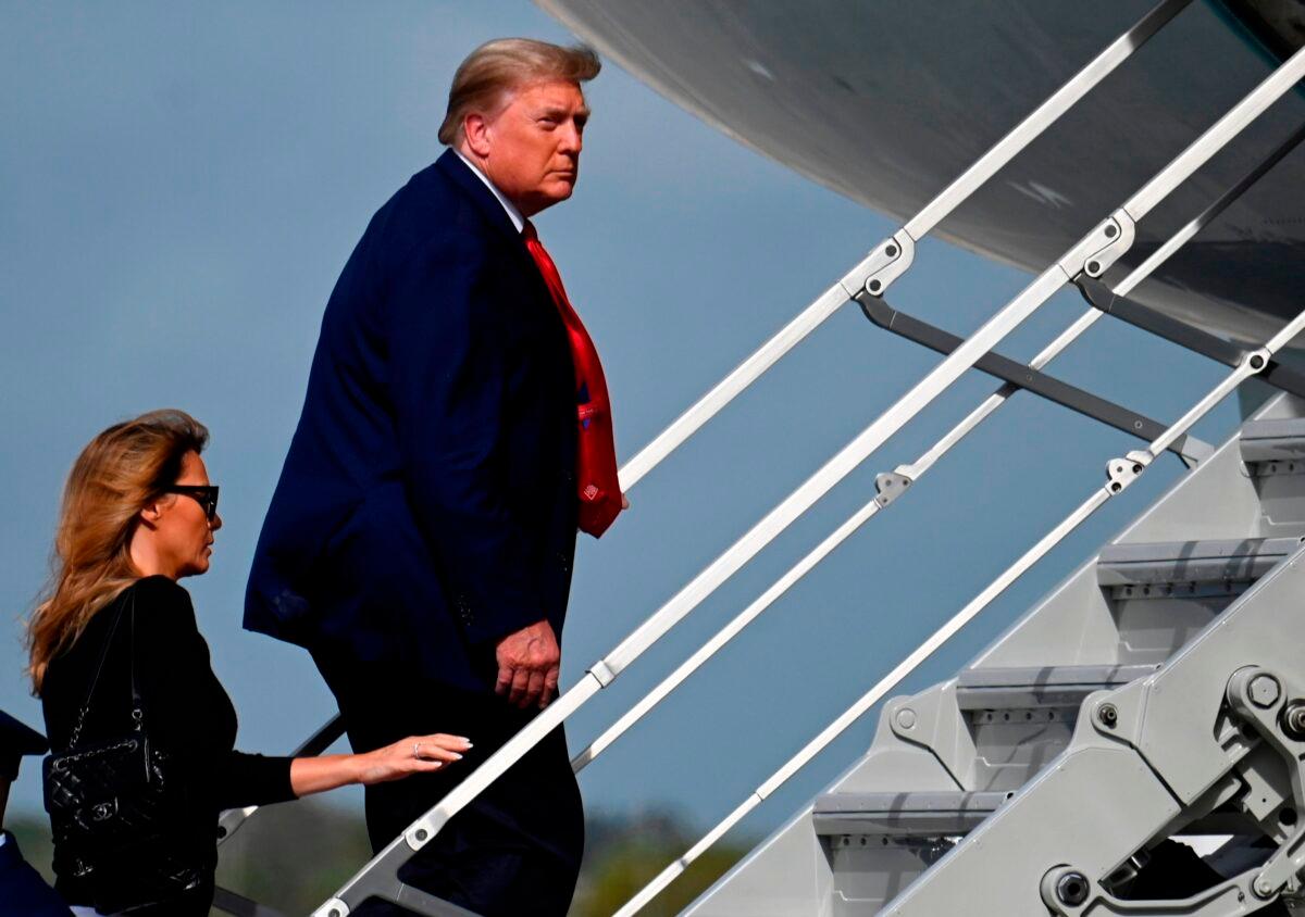 President Donald Trump boards Air Force One with First Lady Melania Trump at Palm Beach International Airport in Fla., on Dec. 31, 2020 (Andrew Caballero-Reynolds/AFP via Getty Images)