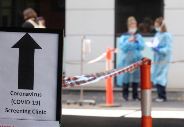 A sign directing people to the COVID-19 screening area is posted outside the Royal Melbourne Hospital in Melbourne, Australia on March 11, 2020. (Luis Ascui/Getty Images)