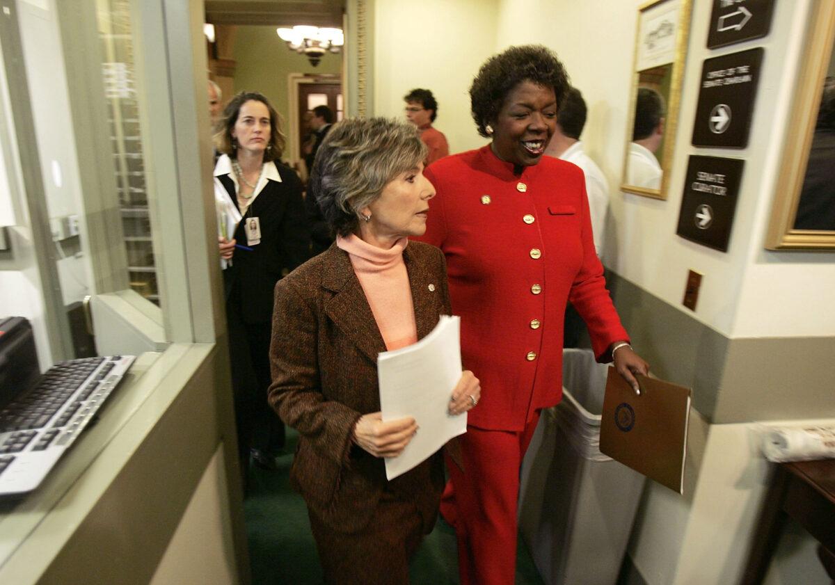 Sen. Barbara Boxer (D-Calif.) (L) and Rep. Stephanie Tubbs Jones (D-Ohio) walk to a press conference to announce their objection to the certification of Ohio electoral votes, in Washington, on Jan. 6, 2005. (Mark Wilson/Getty Images)