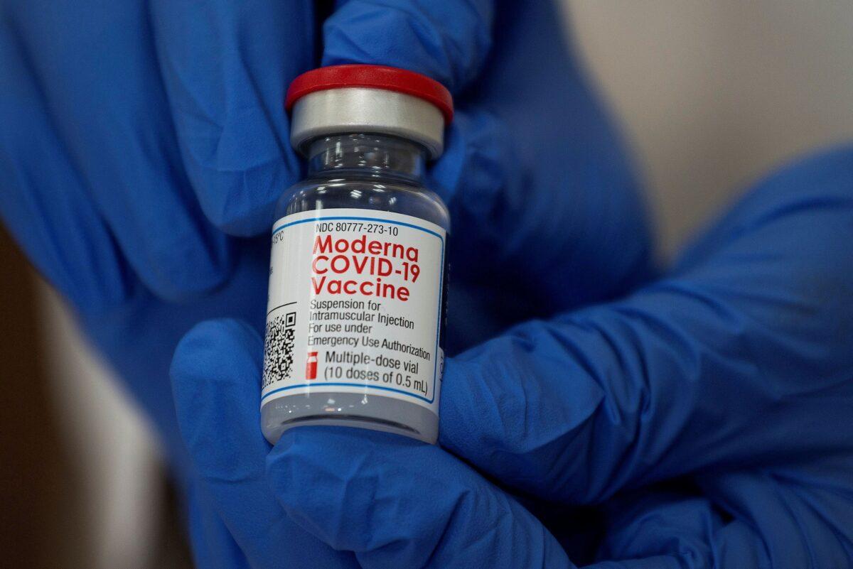 An employee shows the Moderna COVID-19 vaccine in New York City in a Dec. 21, 2020, file photograph. (Eduardo Munoz/Reuters)