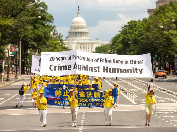 Falun Gong practitioners take part in a parade commemorating the 20th anniversary of the persecution of Falun Gong in China, in Washington on July 18, 2019. (Samira Bouaou/The Epoch Times)