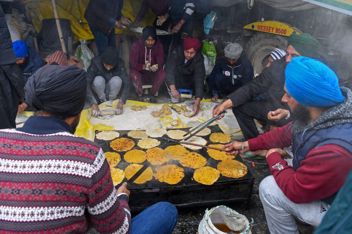 Volunteers cook breakfast as farmers continue to demonstrate against the central government's recent agricultural reforms while blocking a highway at the Delhi-Haryana state border in Singhu on Dec. 30, 2020. (Prakash Singh/AFP via Getty Images)