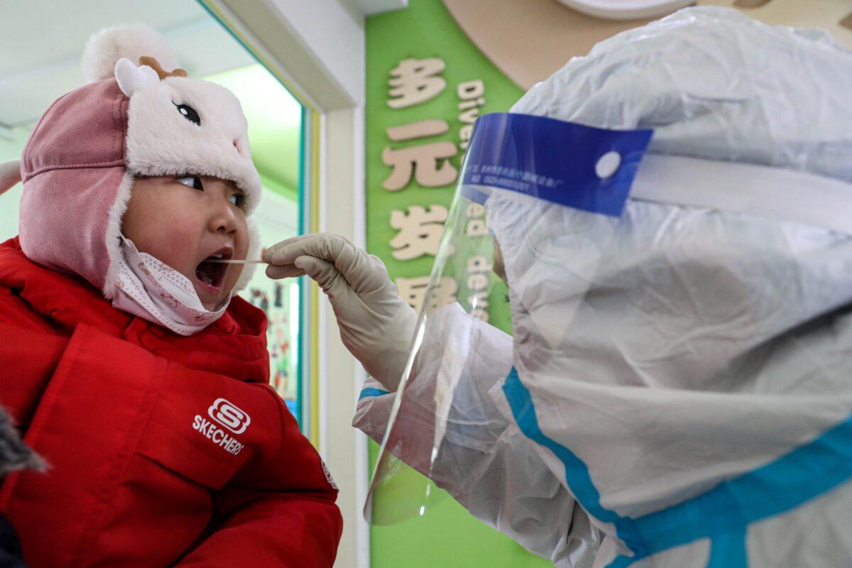 A child takes a COVID-19 swab test in Shenyang, China, on Jan. 1, 2021. (STR/AFP via Getty Images)