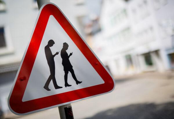A modified caution street close to a school in Reutlingen, southern Germany warning people against excess phone usage while walking. (Christoph Schmidt /DPA/AFP via Getty Images)